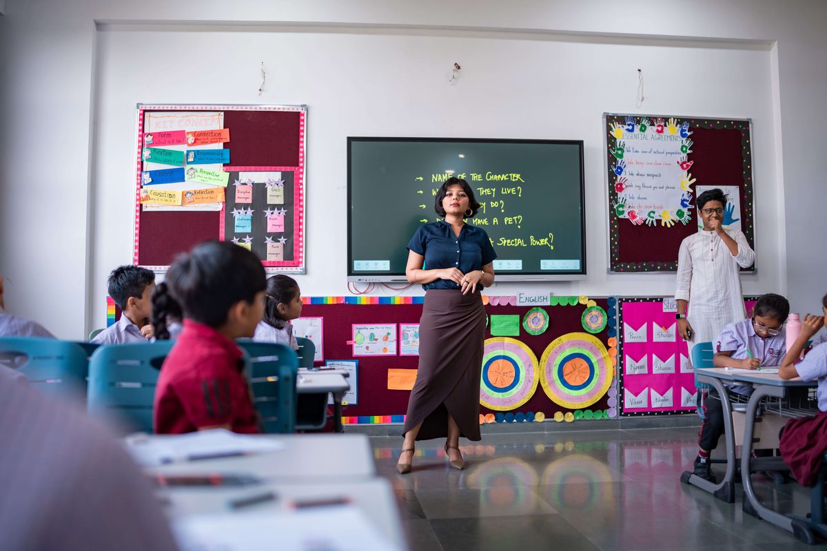Teacher leading a class discussion in a Geneva Liberal School classroom