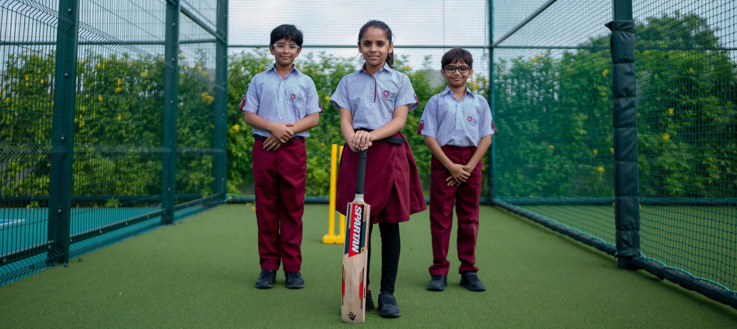 Students playing cricket at the school