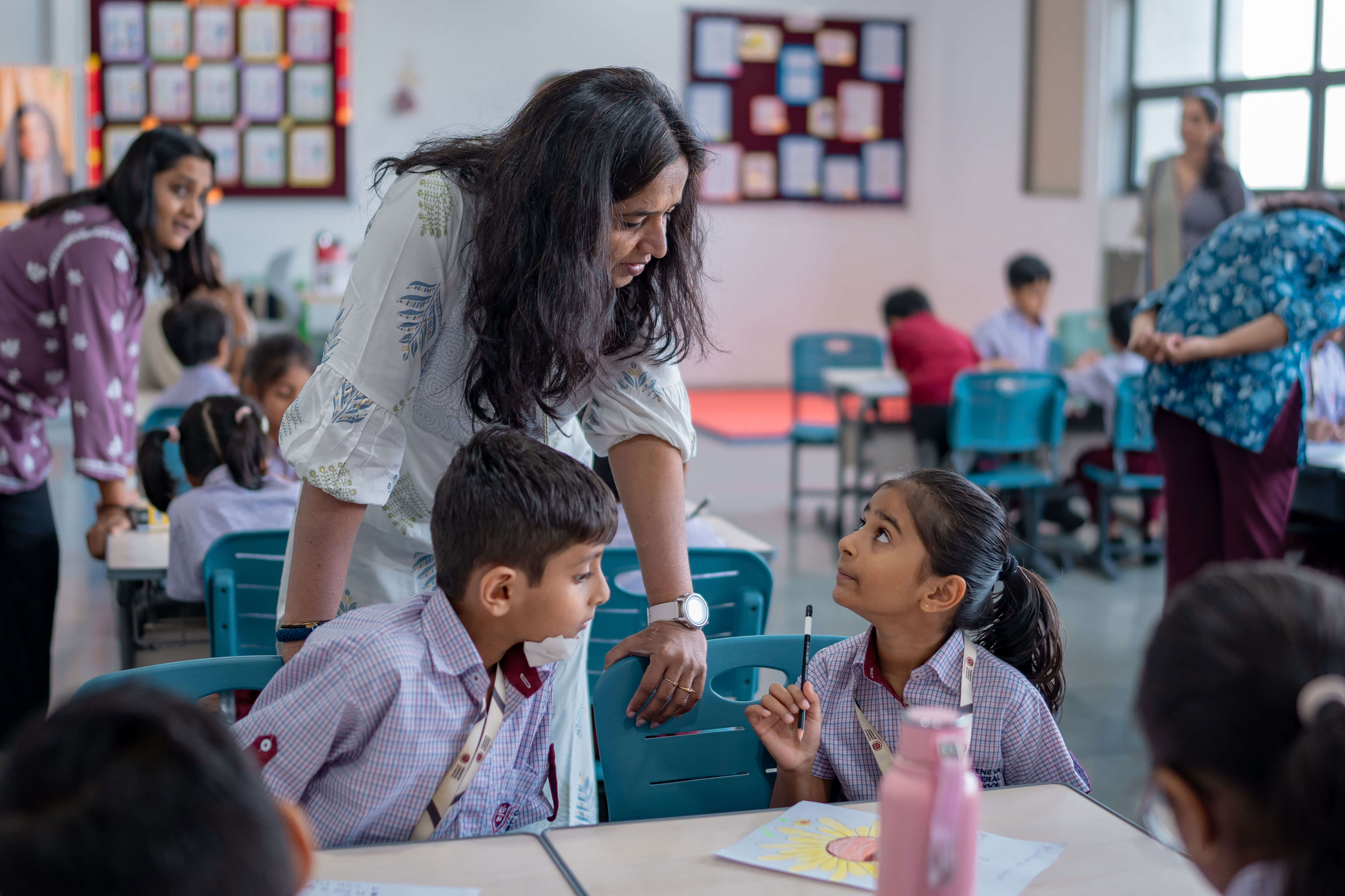 Teacher giving individual guidance to students in class