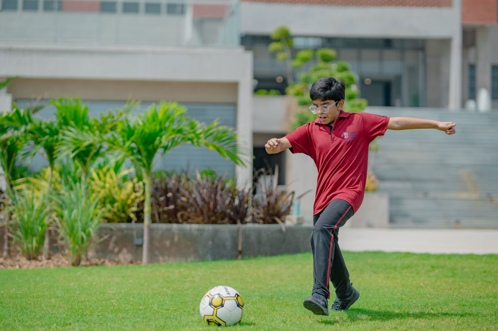 Students playing football on the school ground
