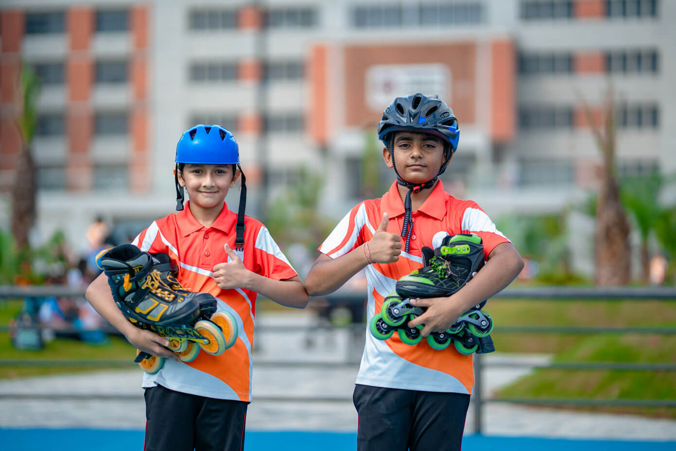 Two students holding inline skates at the campus rink