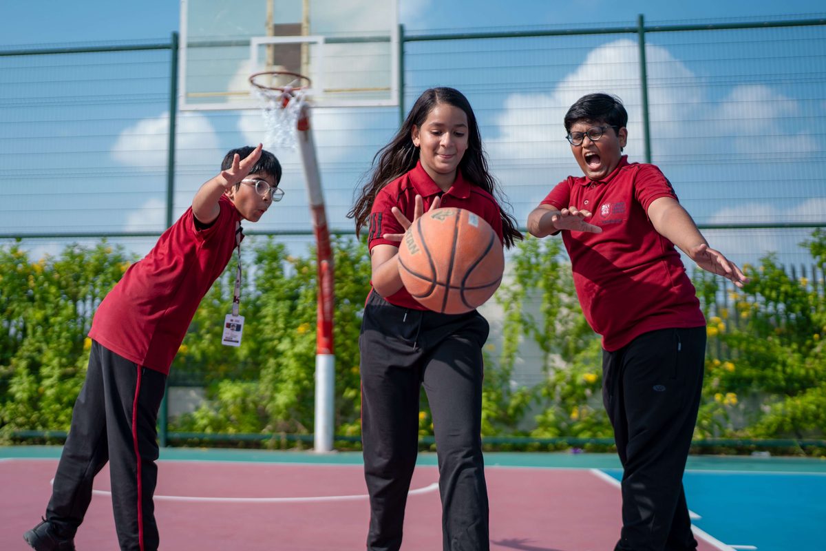 Students playing basketball on the outdoor court
