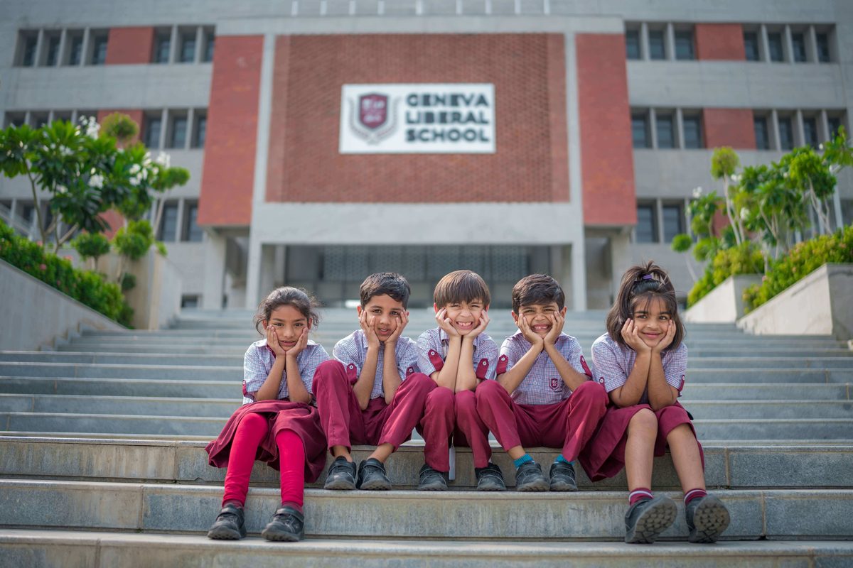 Students seated on the steps outside the Geneva Liberal School building