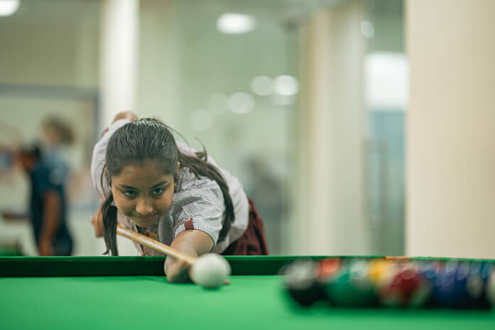 Students playing snooker at the school