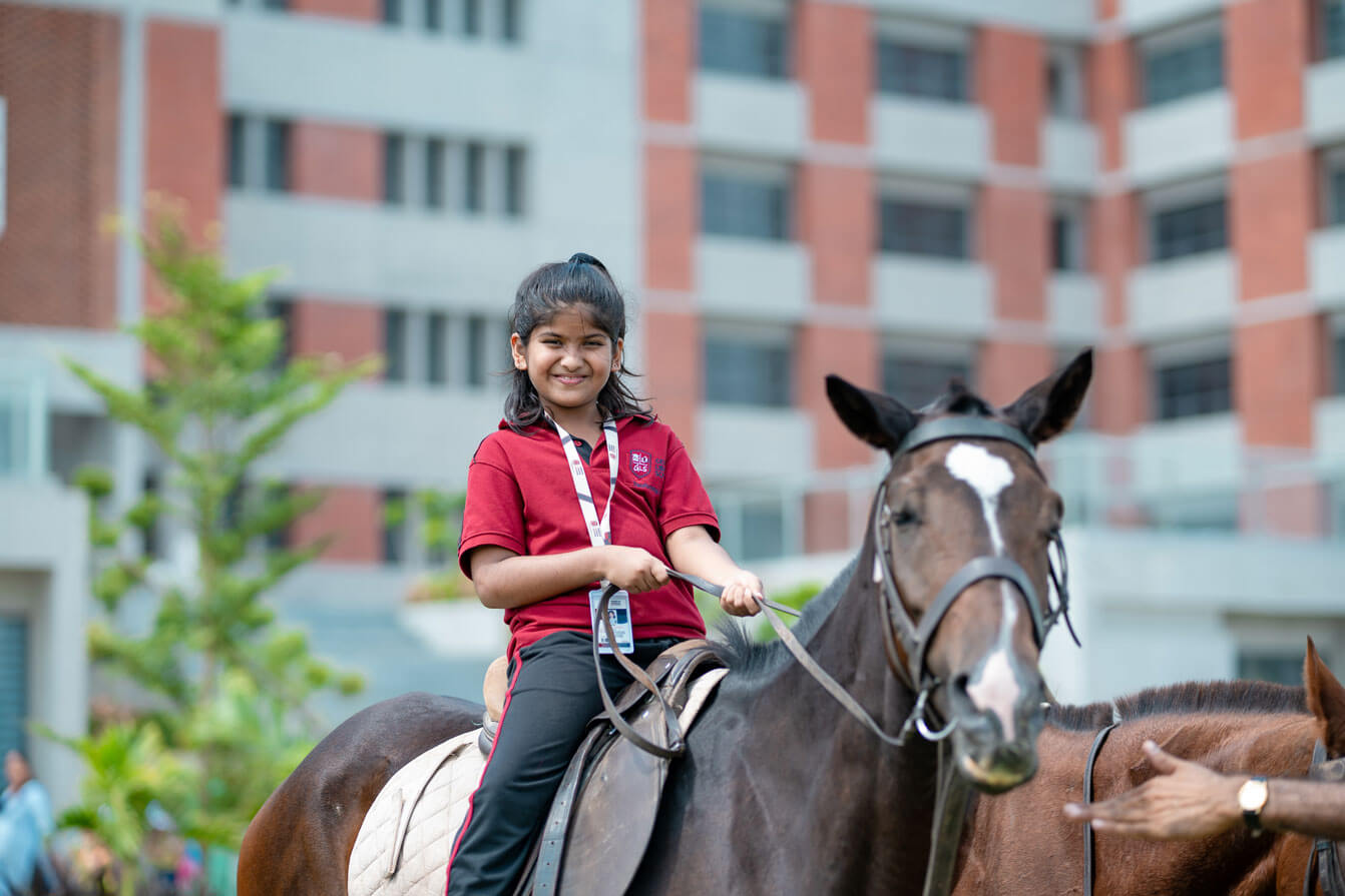 Student horse riding on the Geneva Liberal School campus