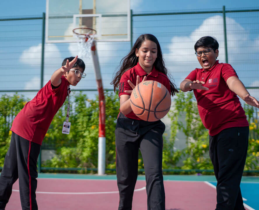 Students playing basketball on the outdoor court