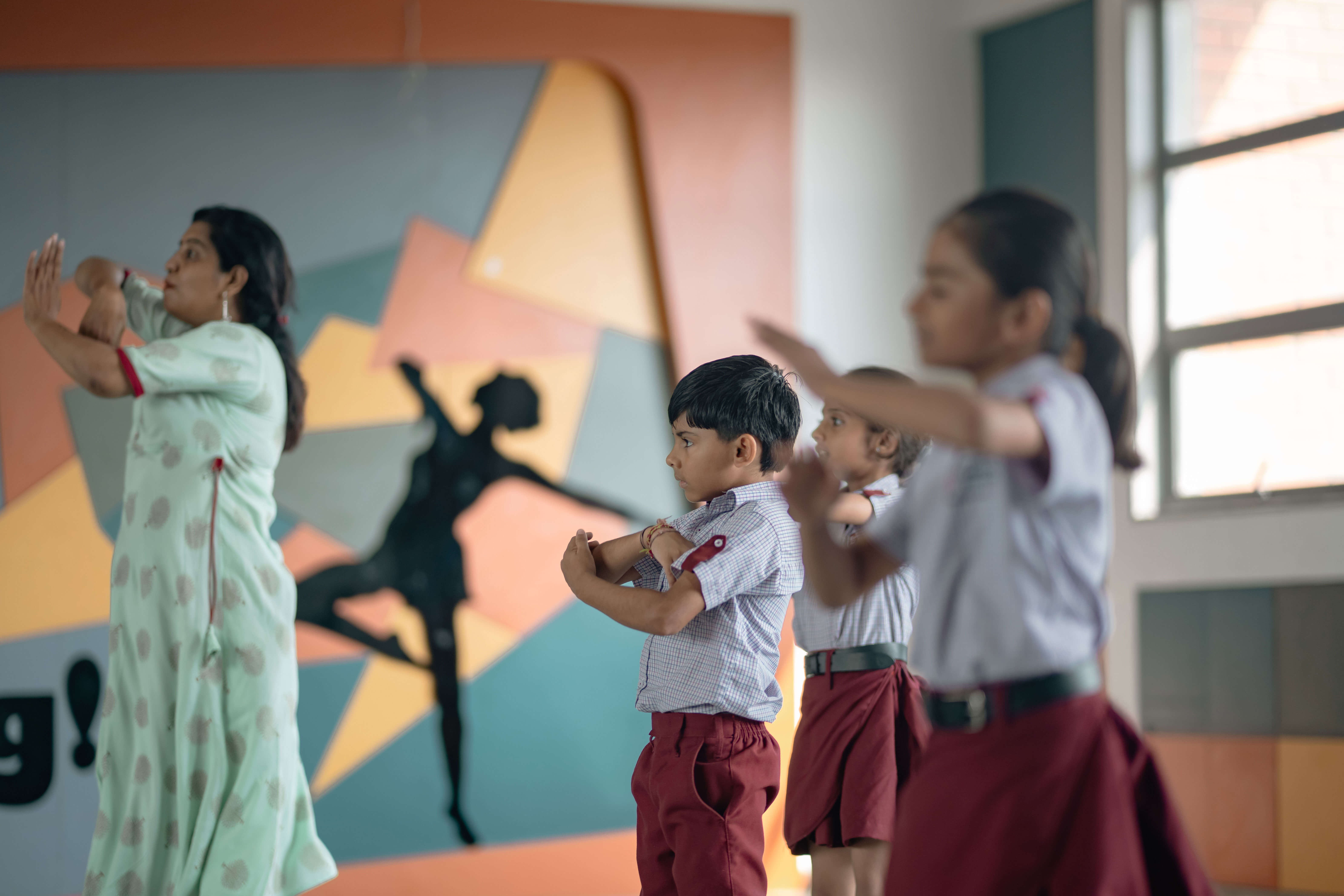 Students taking part in a dance class with their teacher