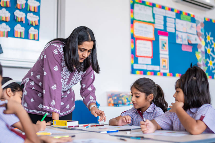 Teacher guiding students during a classroom activity
