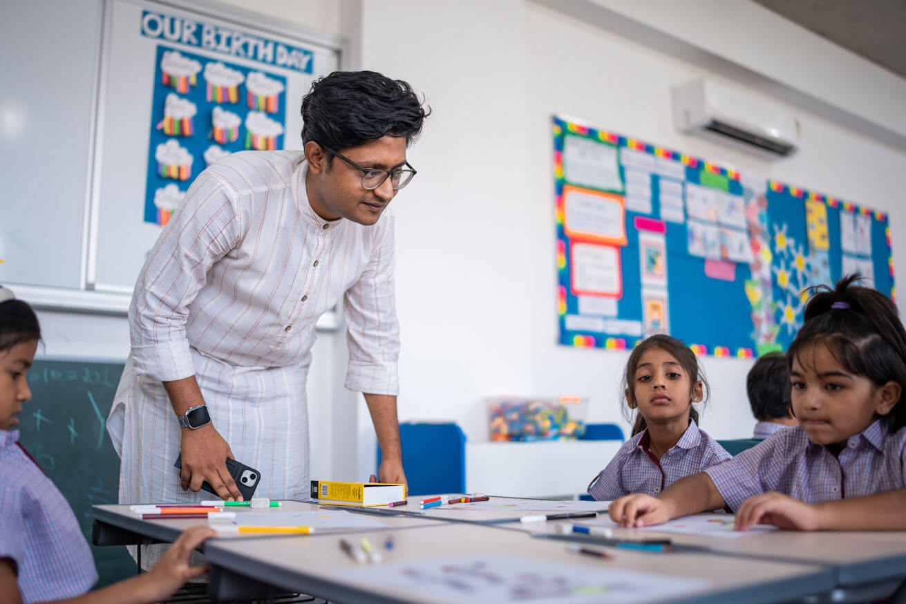 Teacher working with students in an early years classroom
